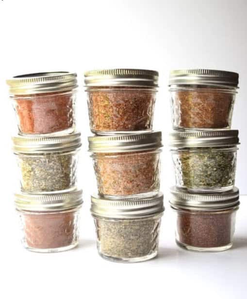 stack of filled spice jars in half pint canning jars for pantry
